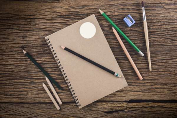 Sketchbook and pencil on a calm desk with soft natural light